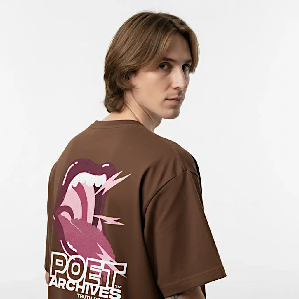 Person wearing a brown t-shirt with a graphic design on the back, set against a plain background
