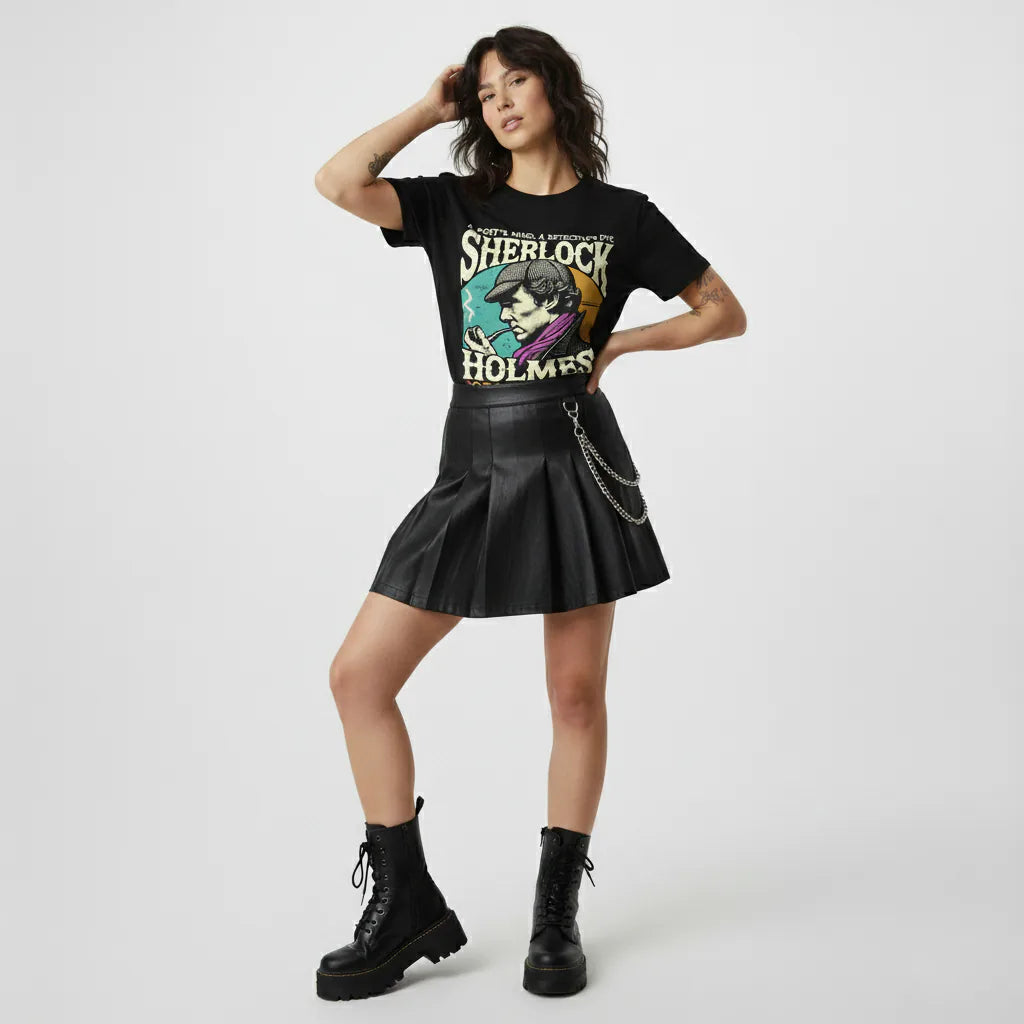 Person wearing a black t-shirt with Sherlock Holmes graphic and a black leather skirt on a white background