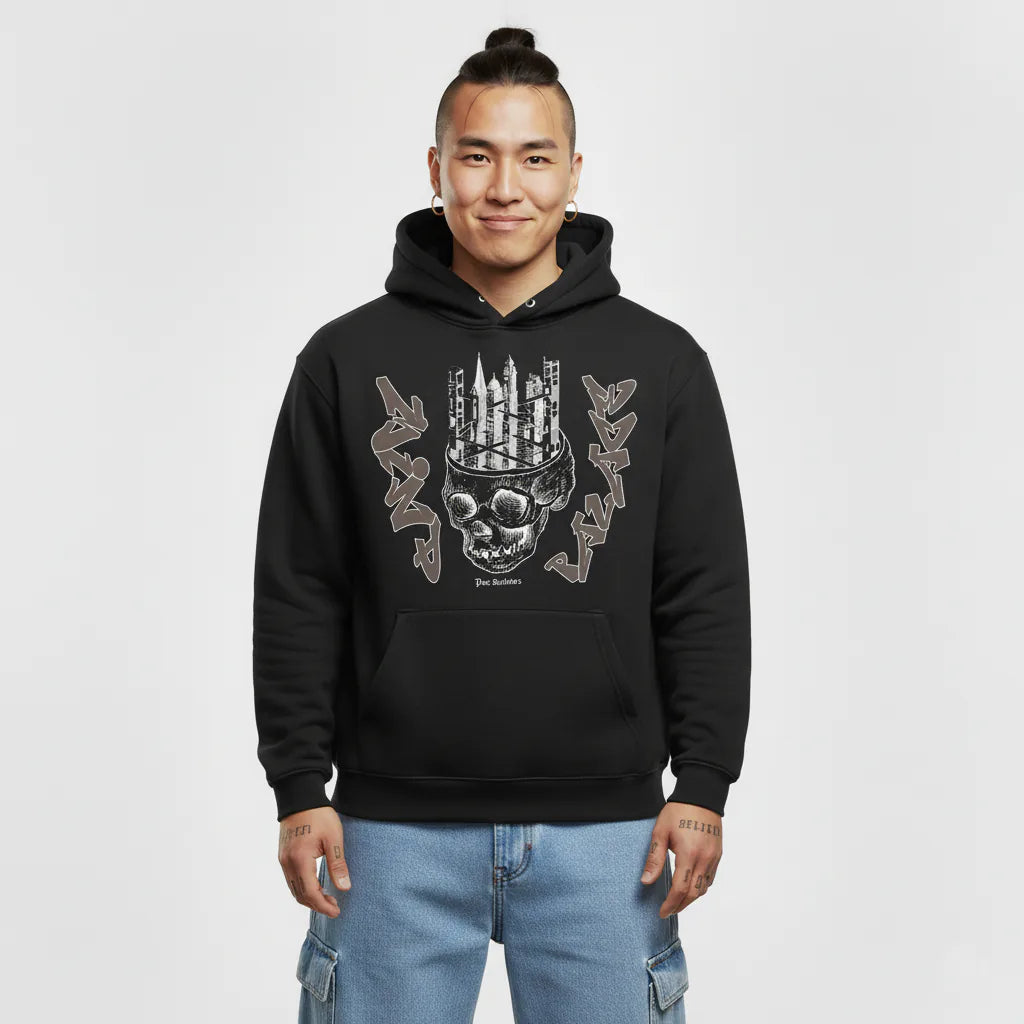 Person wearing a black hoodie with a skull design on a white background
