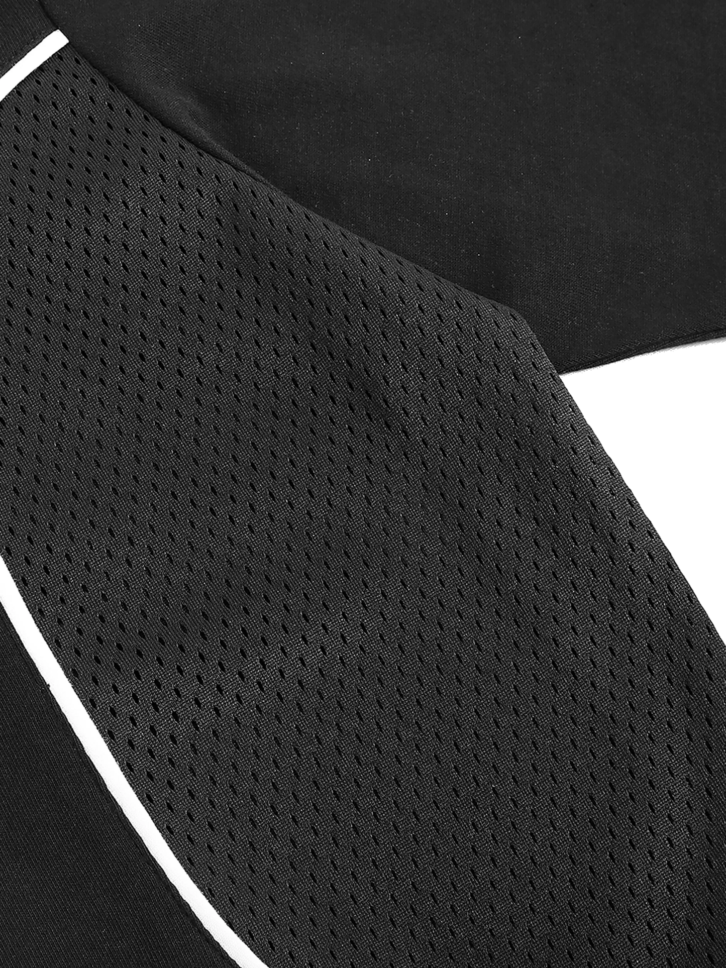 Close-up of a black athletic shirt with white mesh and trim