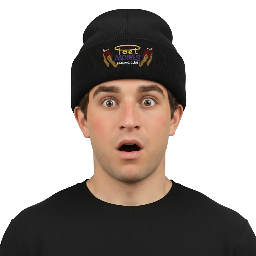 Person wearing a black beanie with embroidered design on a white background