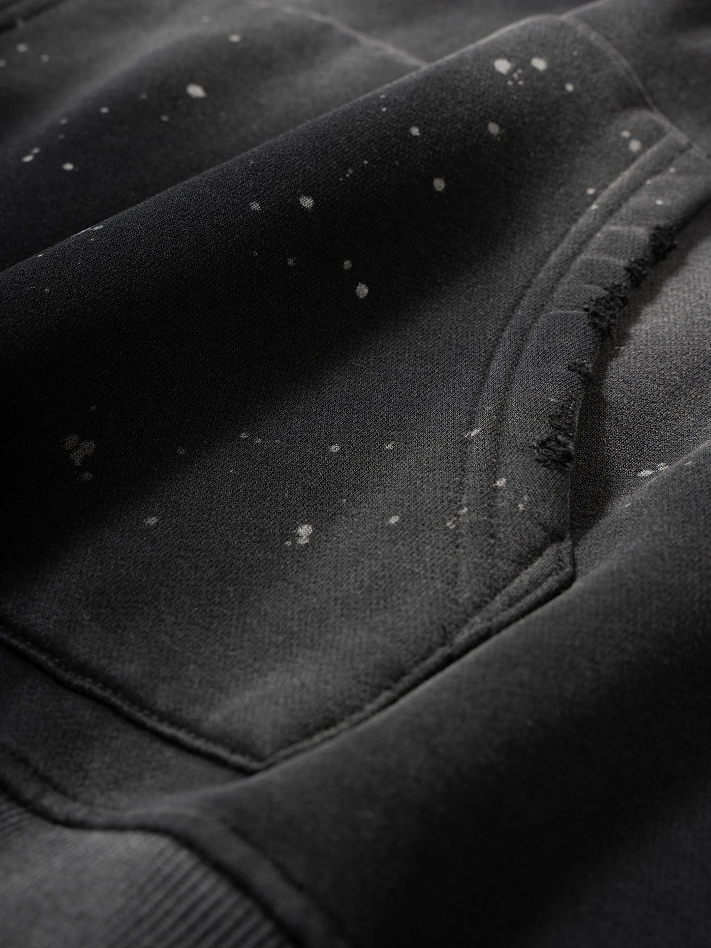 Close-up of a textured black surface with visible fibers