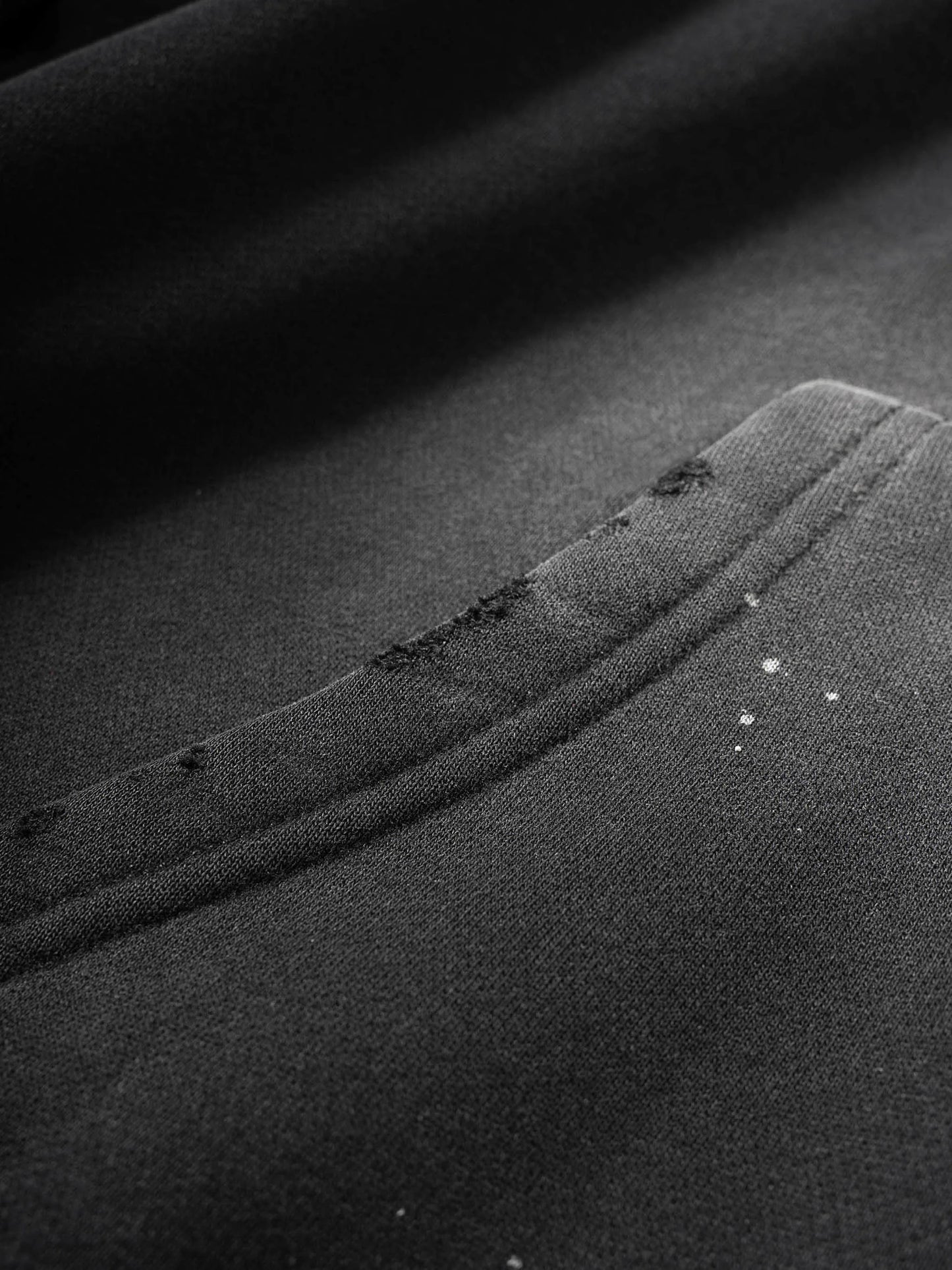 Close-up of black fabric with visible stitching and texture