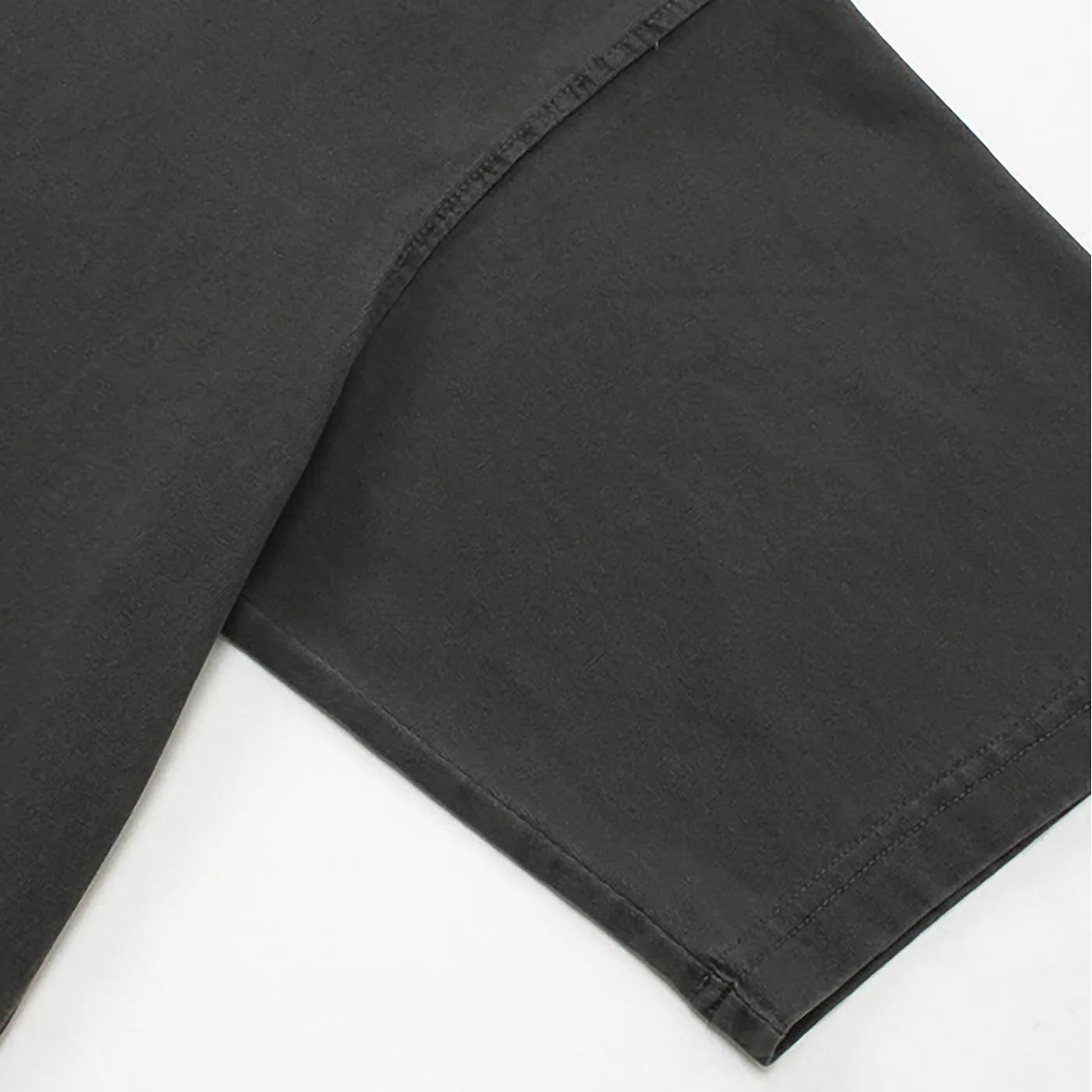 Close-up of black pants on a white background