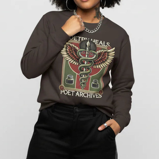 Person wearing a dark brown sweatshirt with graphic design on a light gray background