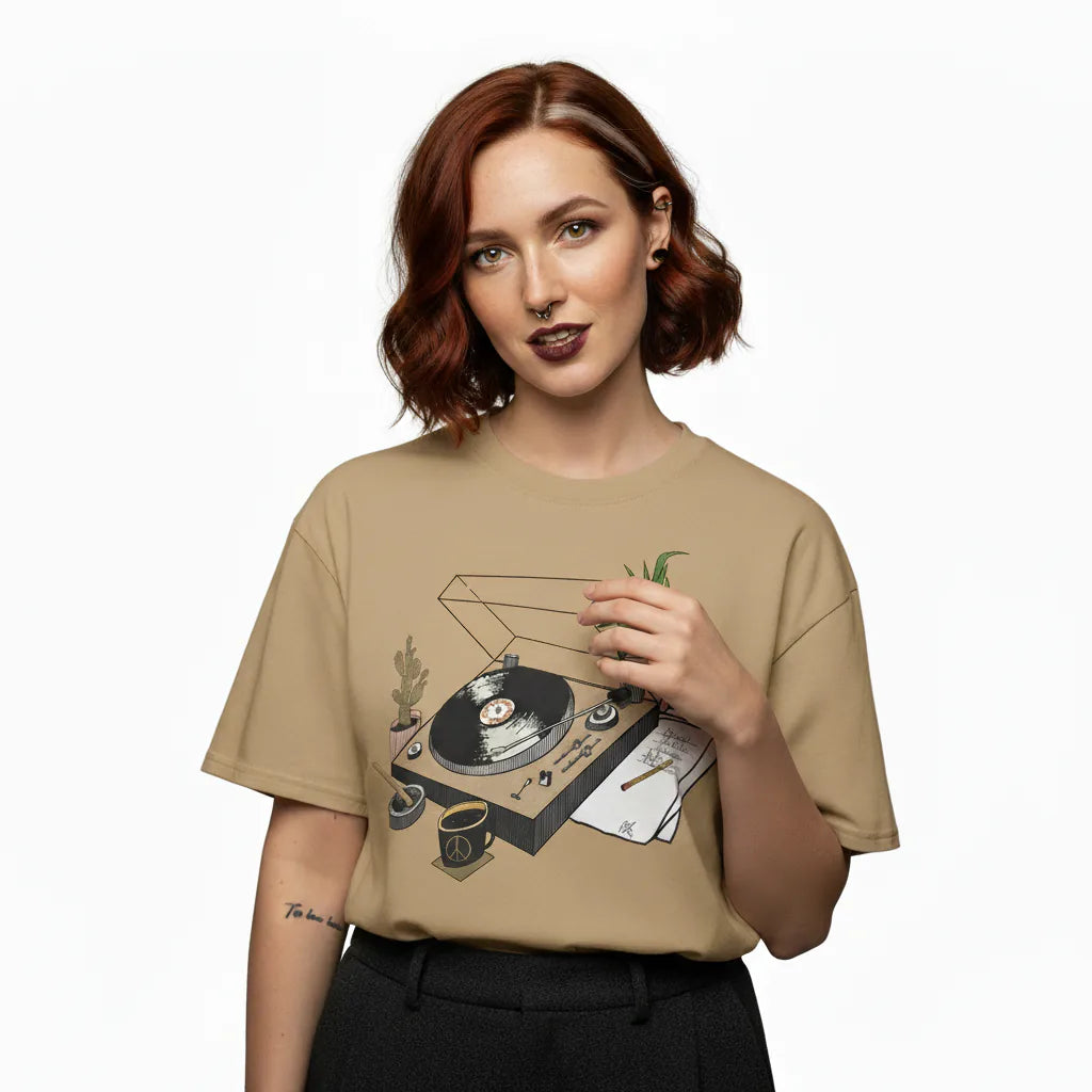 Woman wearing a beige t-shirt with a graphic design on a white background