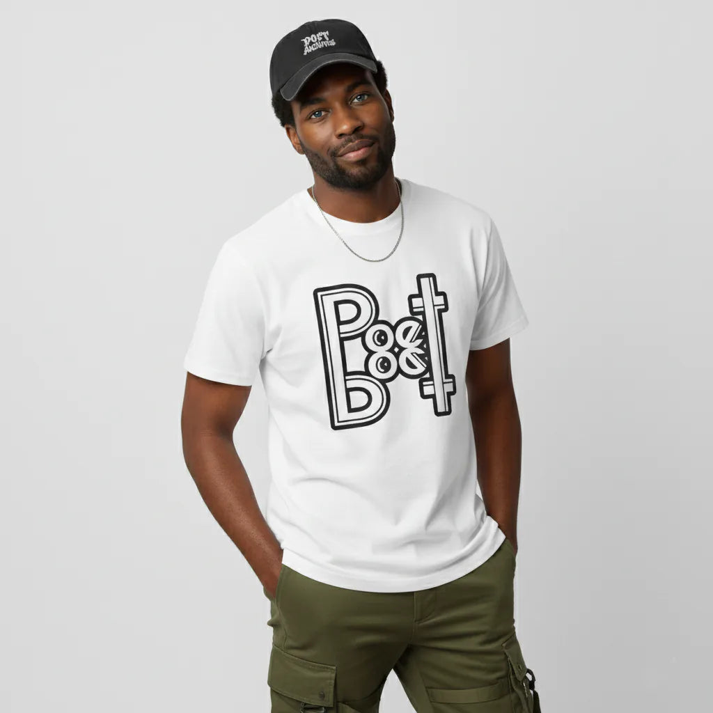 Man wearing a white t-shirt with a graphic design and a black cap on a plain background