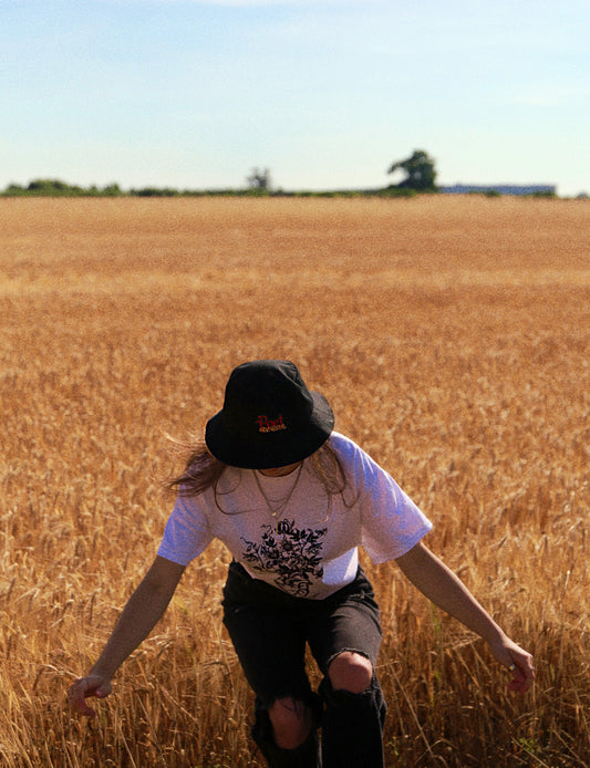 girl in bucket hat wheat field film grain photoshoot