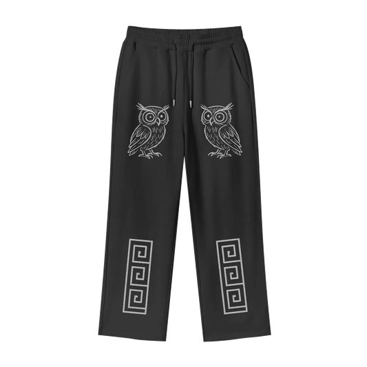 Black pants with owl and geometric designs on a white background