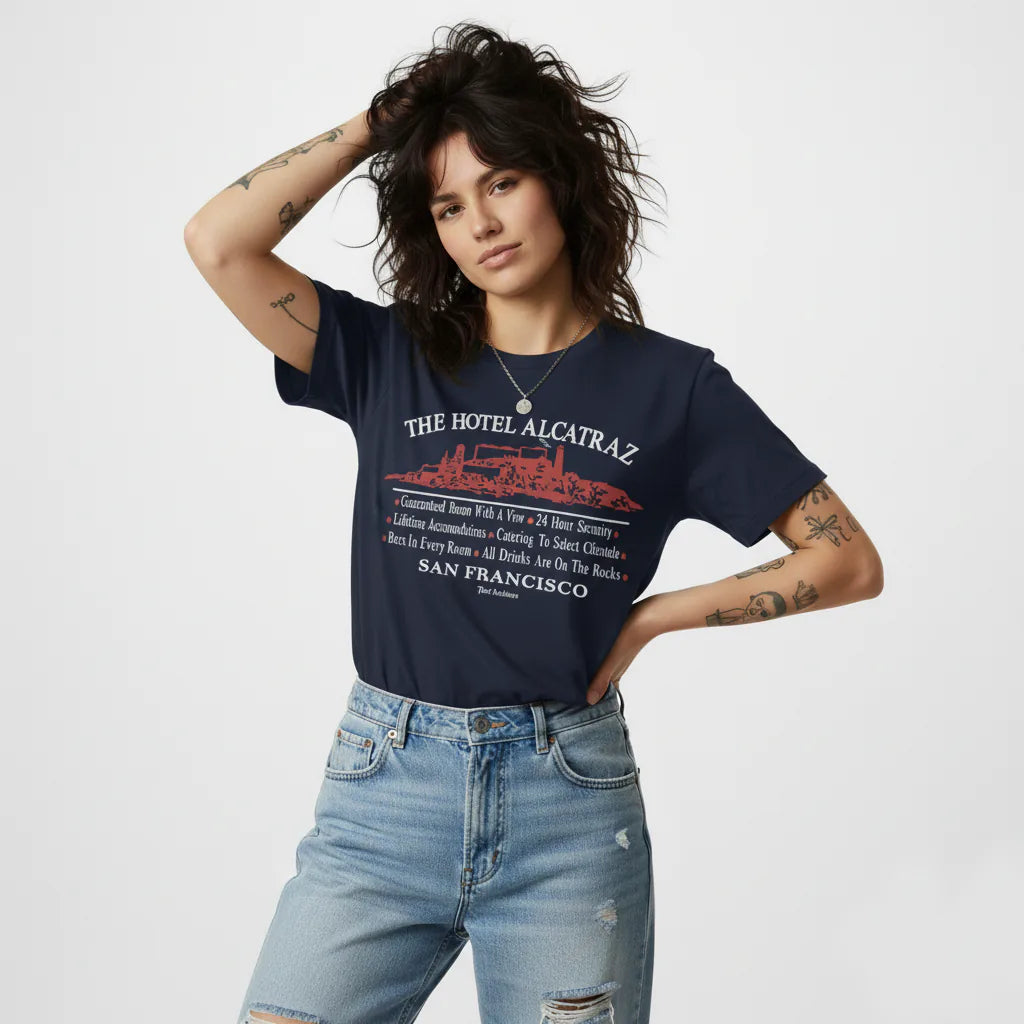 Woman wearing a navy blue t-shirt with 'The Hotel Alcatraz' design on a white background