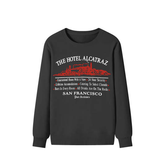 A black crewneck sweatshirt with a red and white graphic print on the front reading 'THE HOTEL ALCATRAZ' and 'SAN FRANCISCO Port Archipelos' with a red boat illustration, shown on a plain white background.