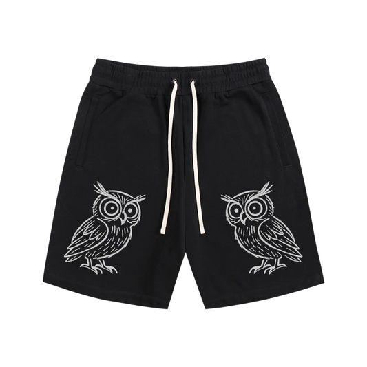 Black shorts with white owl designs on a white background