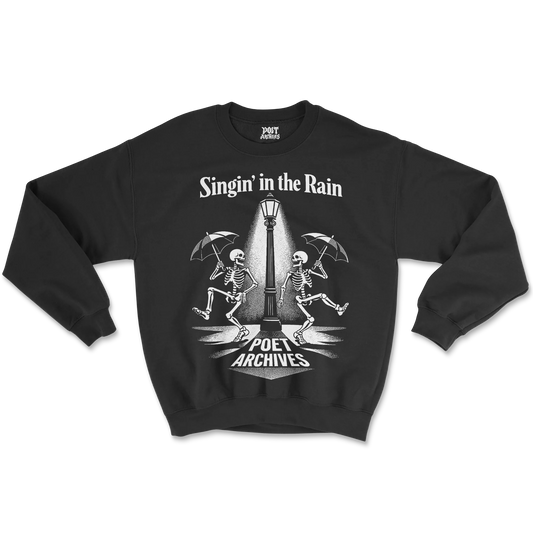 Black sweatshirt with skeleton design and text 'Singin' in the Rain' on a white background
