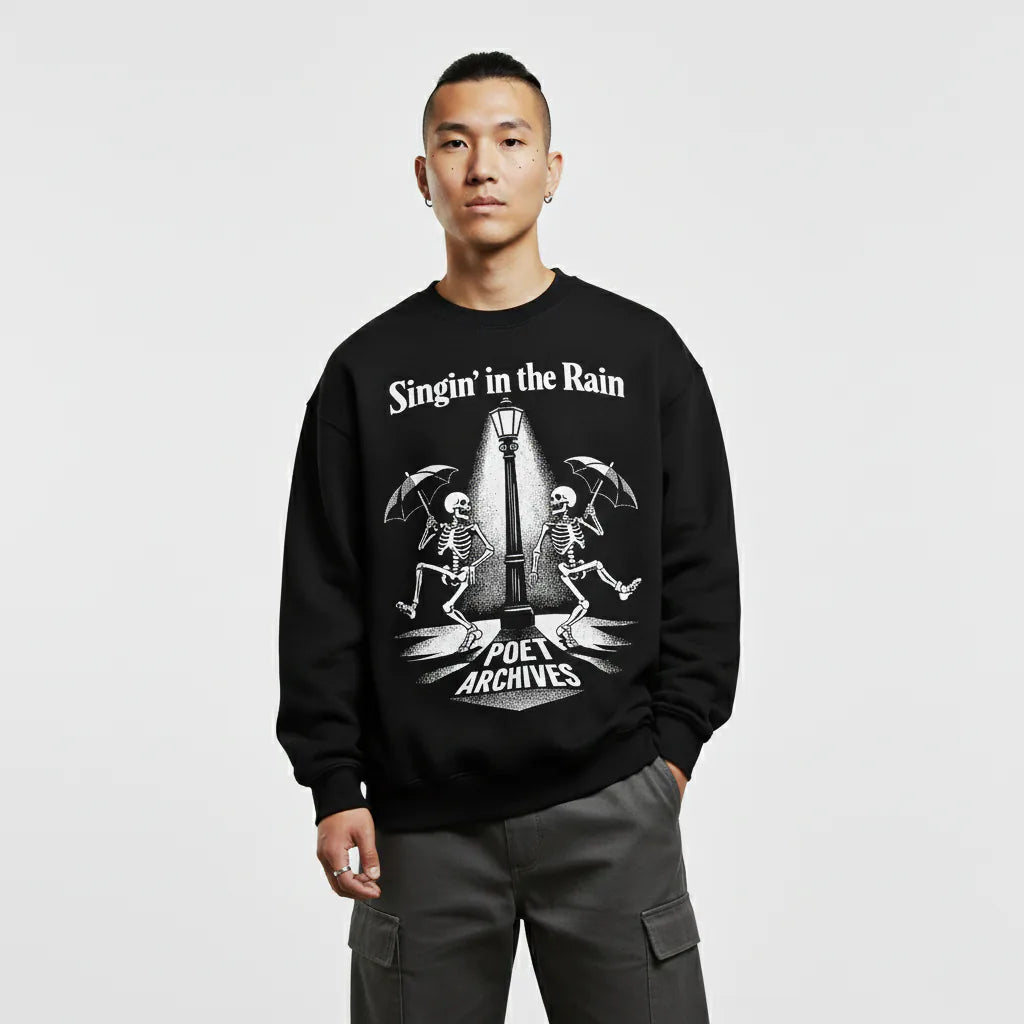 Person wearing a black sweatshirt with a graphic design and text on a light gray background