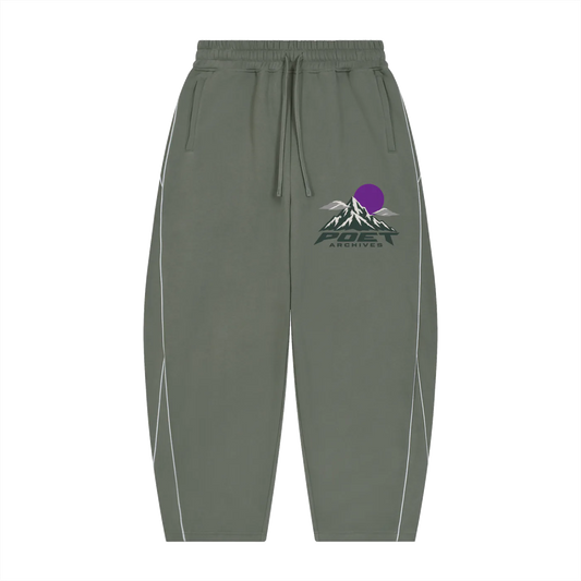 Olive green jogger sweatpants with a drawstring waist, featuring a mountain and sun graphic with the text 'POET ARCHIVES' on the left thigh and white piping details along the sides.