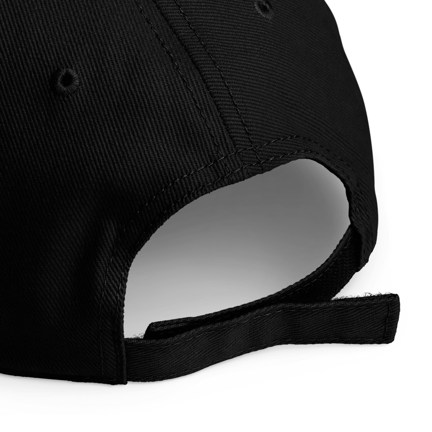 Close-up of the back strap area of a black baseball cap, showing the fabric texture and adjustable closure on a white background.