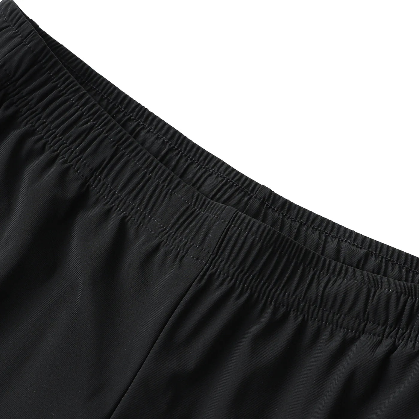 Close-up of black shorts with an elastic waistband on a white background