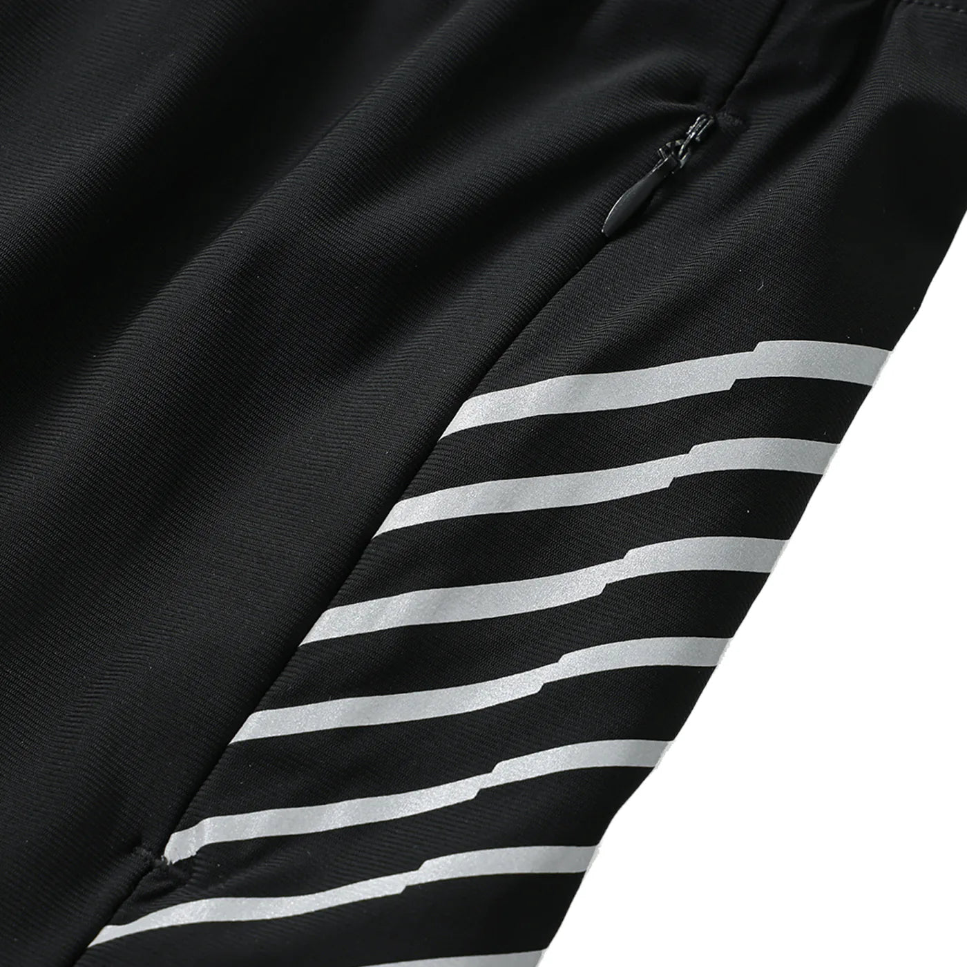 Close-up of a black jacket with reflective white stripes on a white background