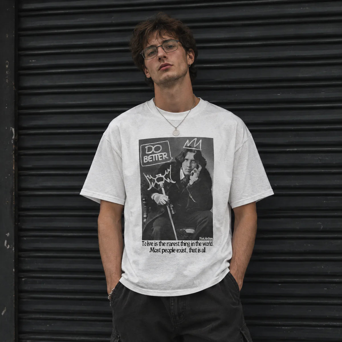 A man wearing a white graphic t-shirt with a black and white print of Oscar Wilde and the text 'DO BETTER'
