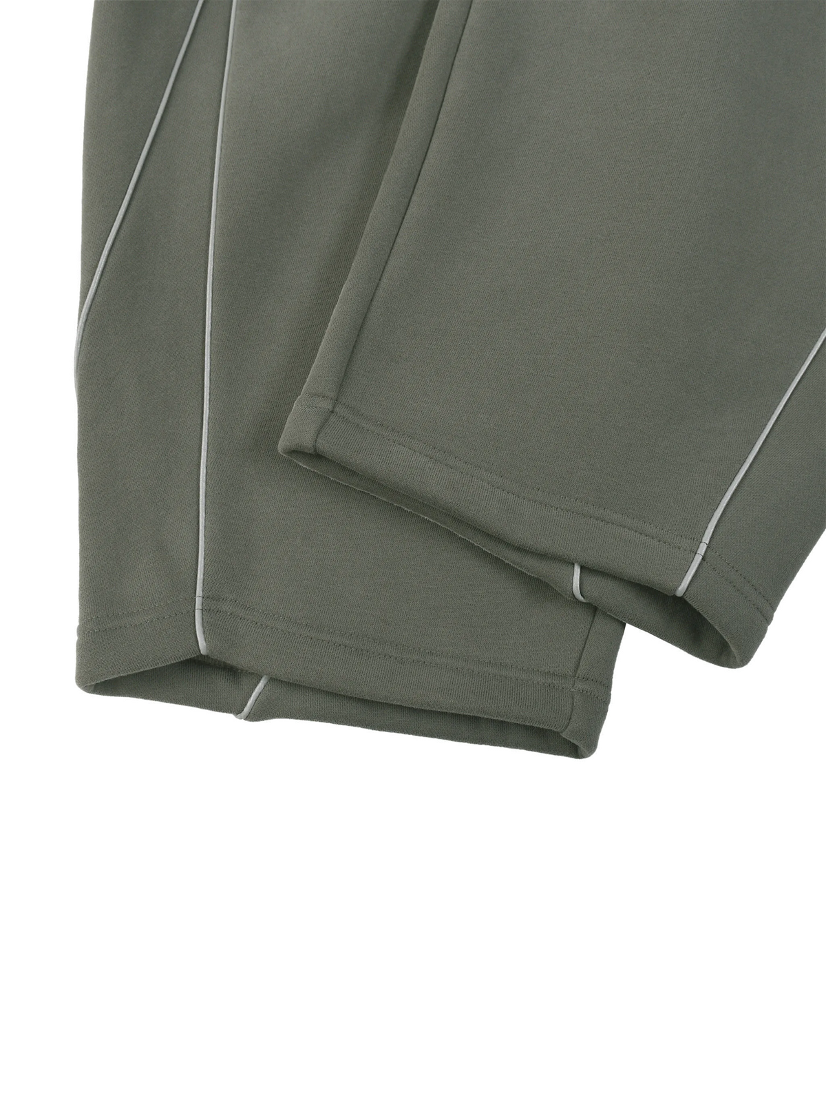 Close-up of olive green pants with white contrast stitching along the leg seams and hem, shown on a plain white background.