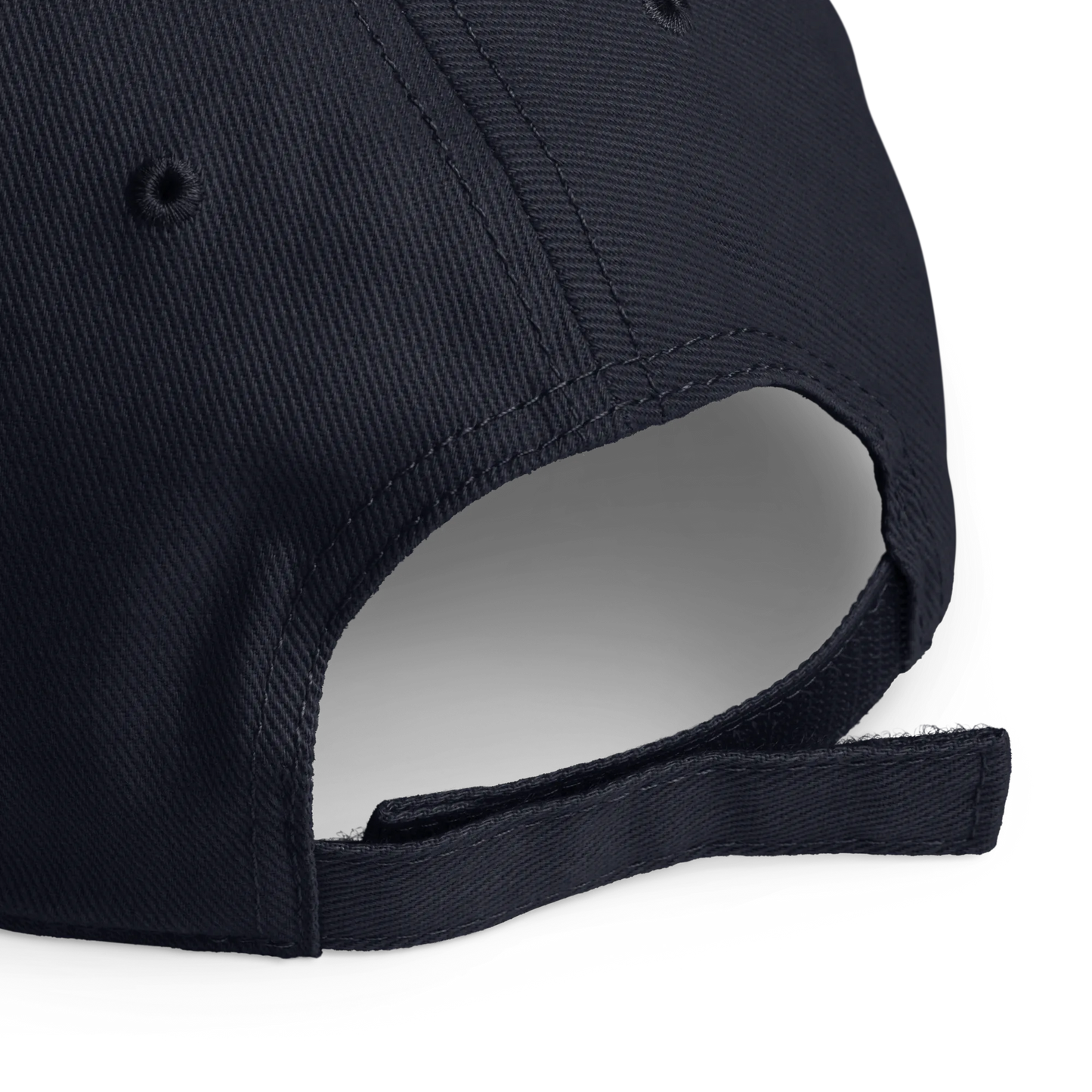 Close-up of the back of a dark navy blue baseball cap, showing the fabric texture, ventilation eyelets, and adjustable strap closure on a white background.