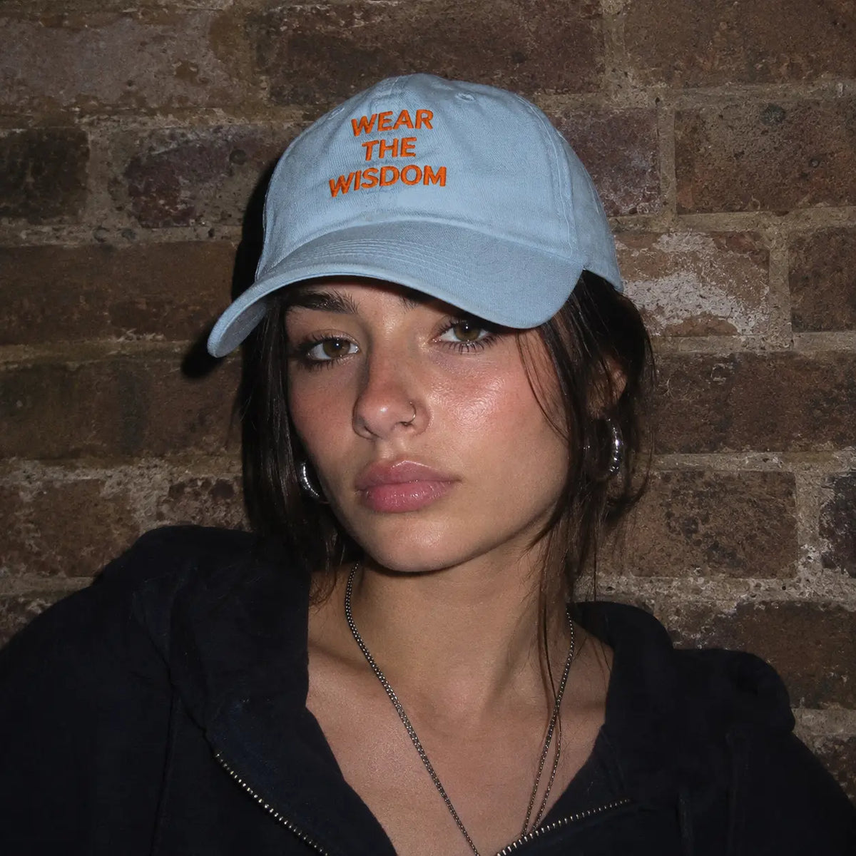 Girl wearing the Athena Cap from Poet Archives, featuring the 'Wear the Wisdom' print