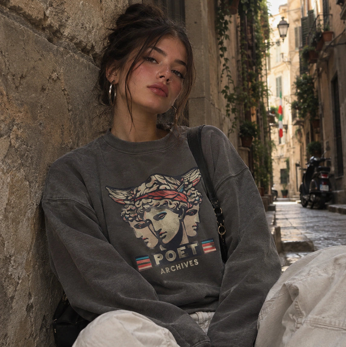 Woman wearing a gray Hermes Sweatshirt featuring a Greek-inspired graphic and 'Poet Archives' text
