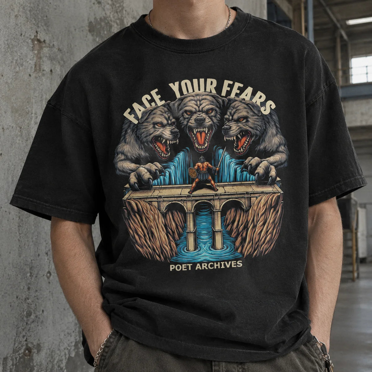 A person wearing a black graphic T-shirt in an industrial indoor setting. The shirt features a large front print with three roaring wolves behind a bridge over blue water, with the text 'FACE YOUR FEARS' above and 'POET ARCHIVES' below.