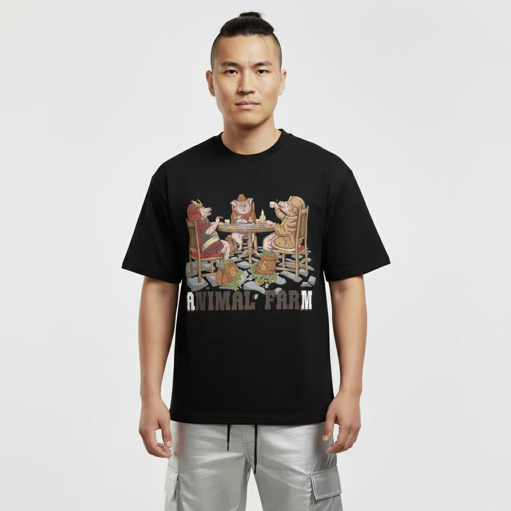 Person wearing a black t-shirt with 'Animal Farm' graphic design on a white background