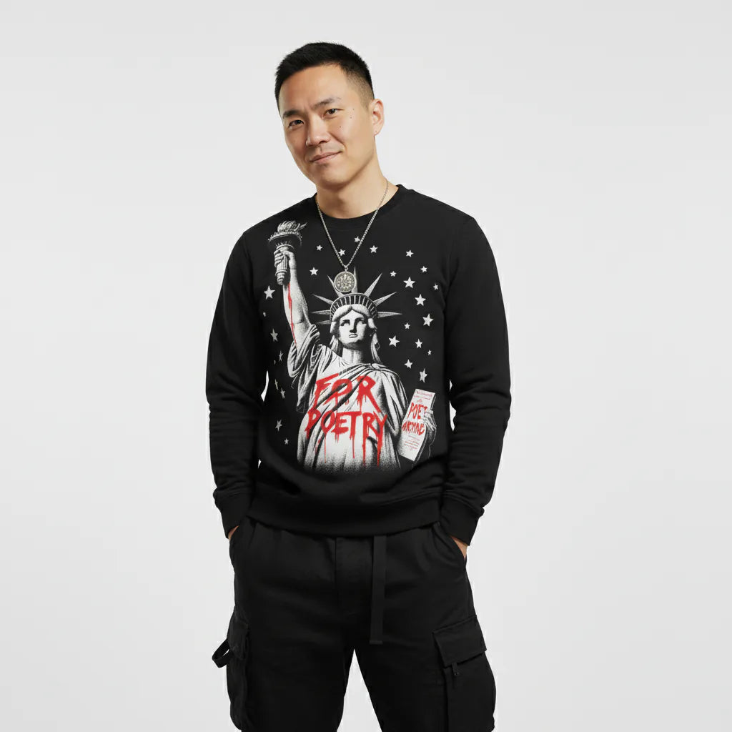 Person wearing a black sweatshirt with a graphic design on a plain background