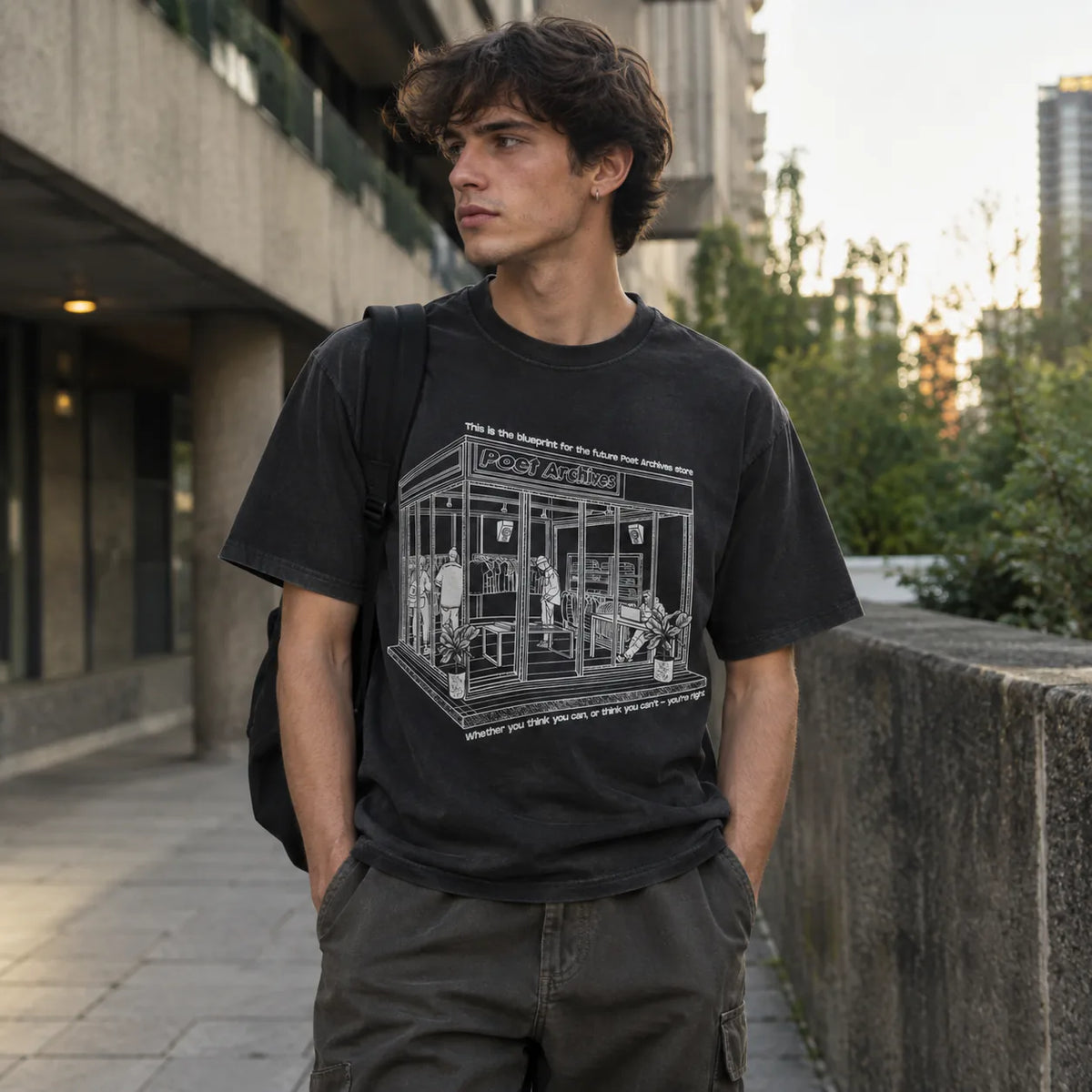 Close-up of the blueprint storefront graphic and Henry Ford quote printed on a black t-shirt, from Poet Archives