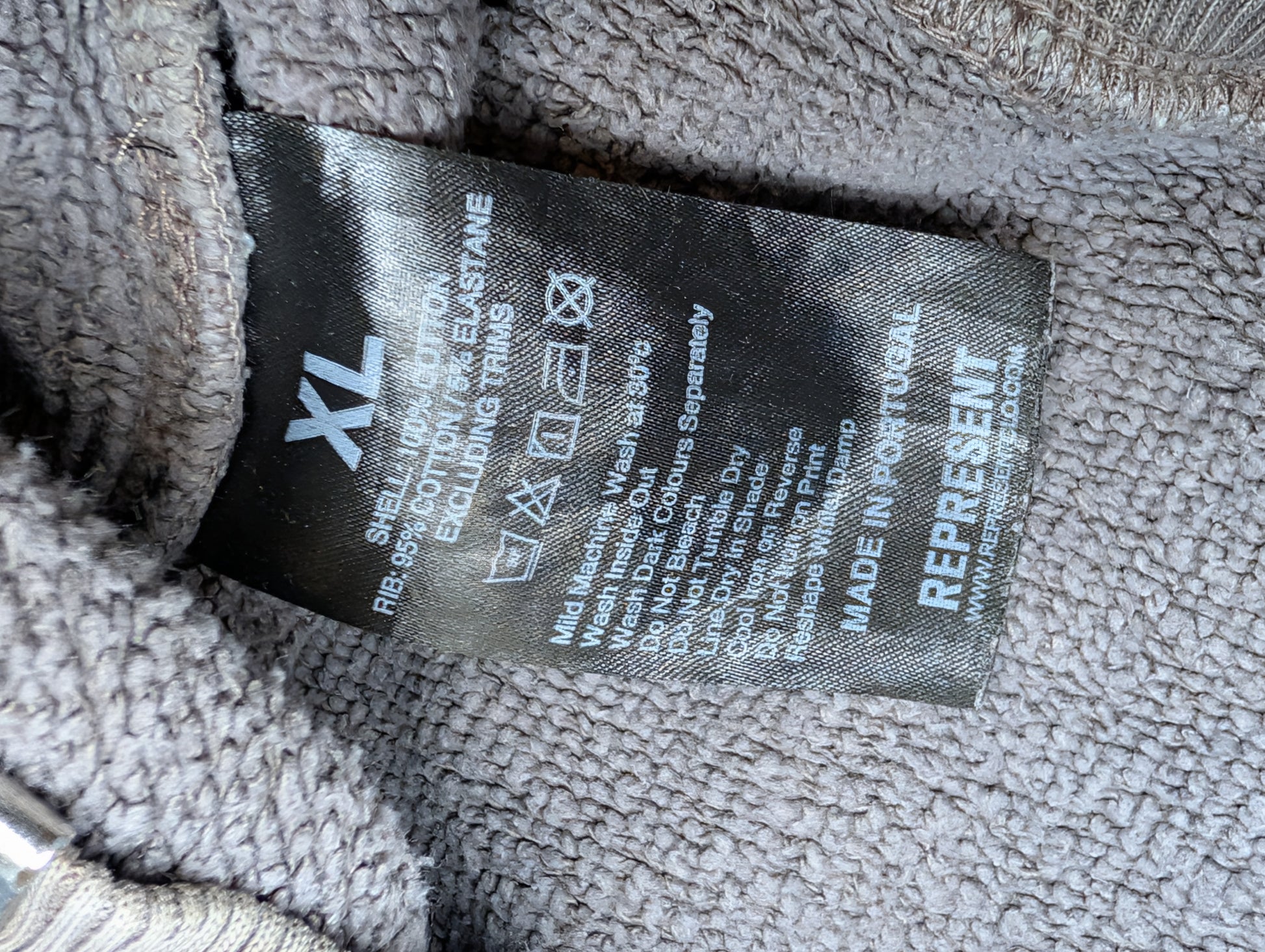 Clothing label on a textured gray fabric background