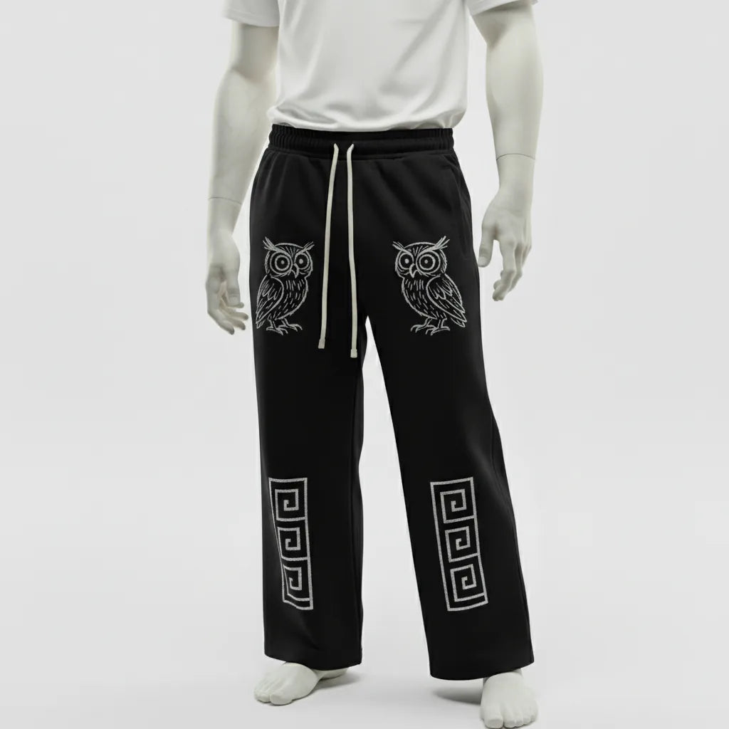 Black pants with owl and geometric designs on a white background