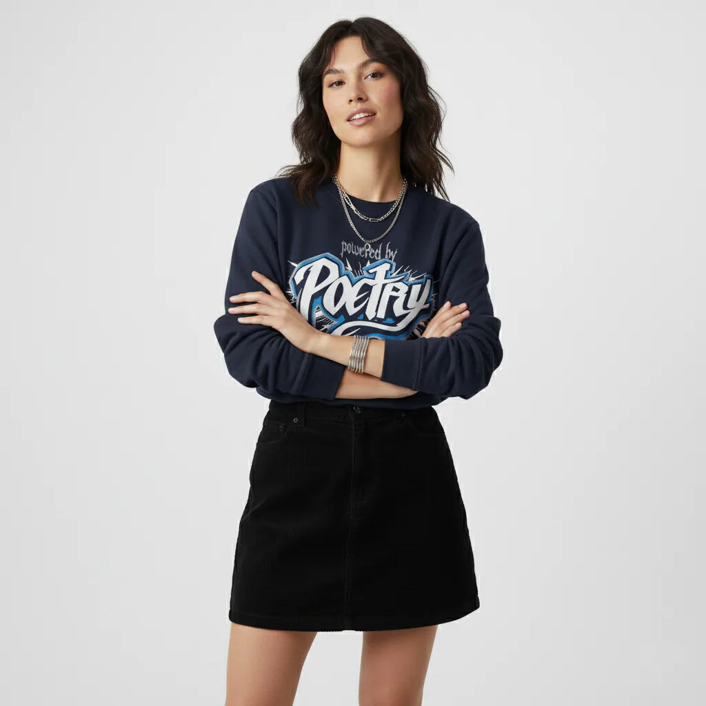 Woman wearing a navy sweatshirt with text and a black skirt on a white background