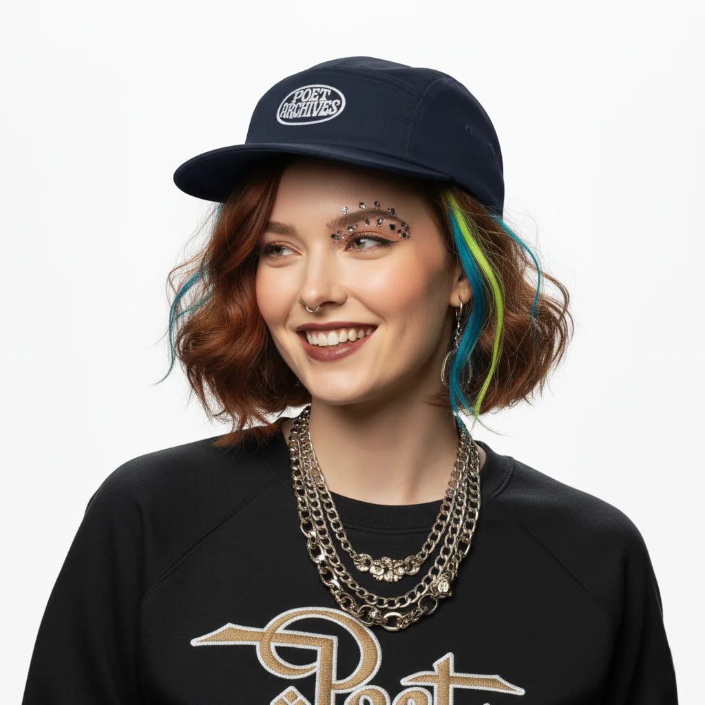 Person wearing a navy cap and black sweatshirt with visible branding on a white background