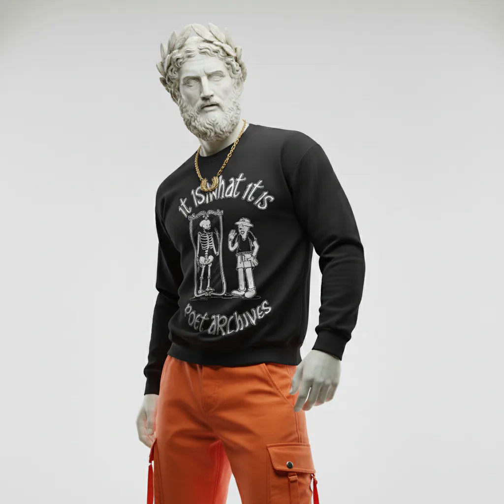 Person wearing a black sweatshirt with graphic design and text, standing against a plain background