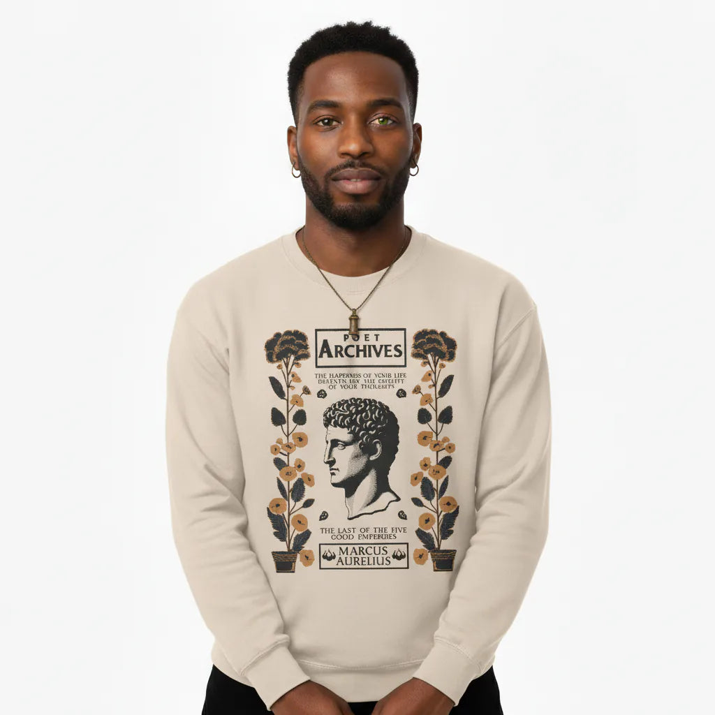 Man wearing a beige sweatshirt with a graphic design on a white background