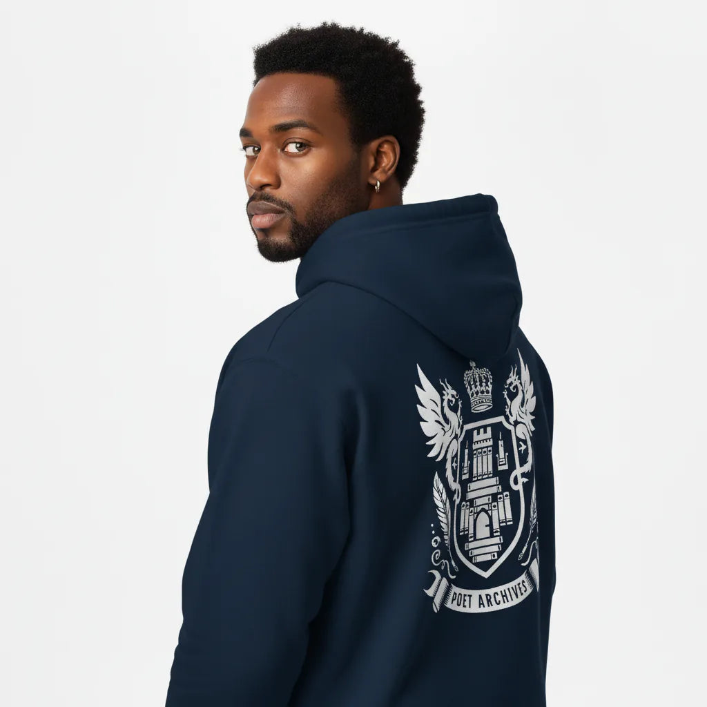 Man wearing a navy hoodie with a white emblem on the back against a light gray background